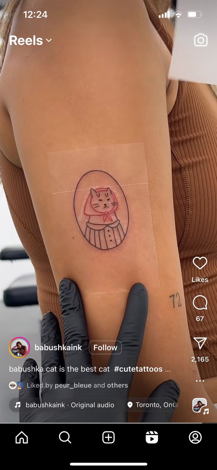 a woman's arm with a tattoo on it that has an image of a cat