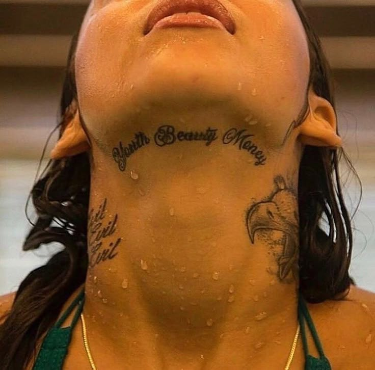 a woman with tattoos on her neck and chest