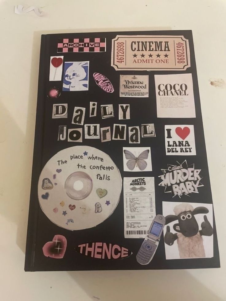 there is a dvd with various stickers on it and the words daily journal next to it