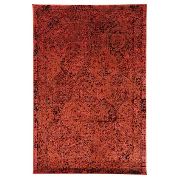 an orange and black rug with ornate design on the bottom, in front of a white background