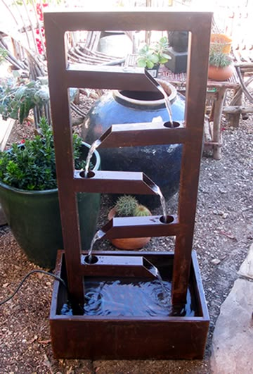 an outdoor fountain with water flowing from it