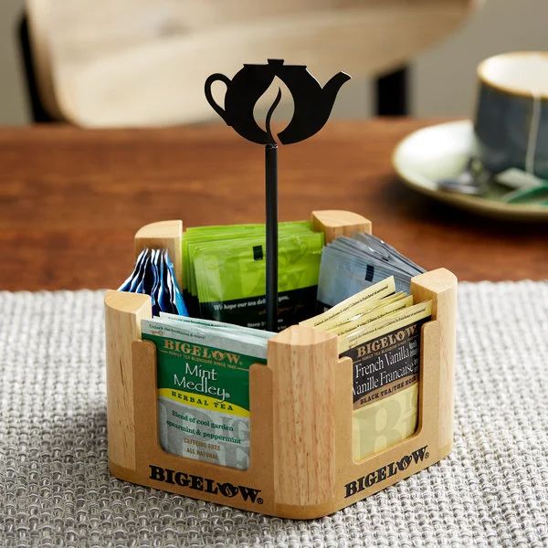 a wooden box with a teapot shaped like a cup and saucer in it