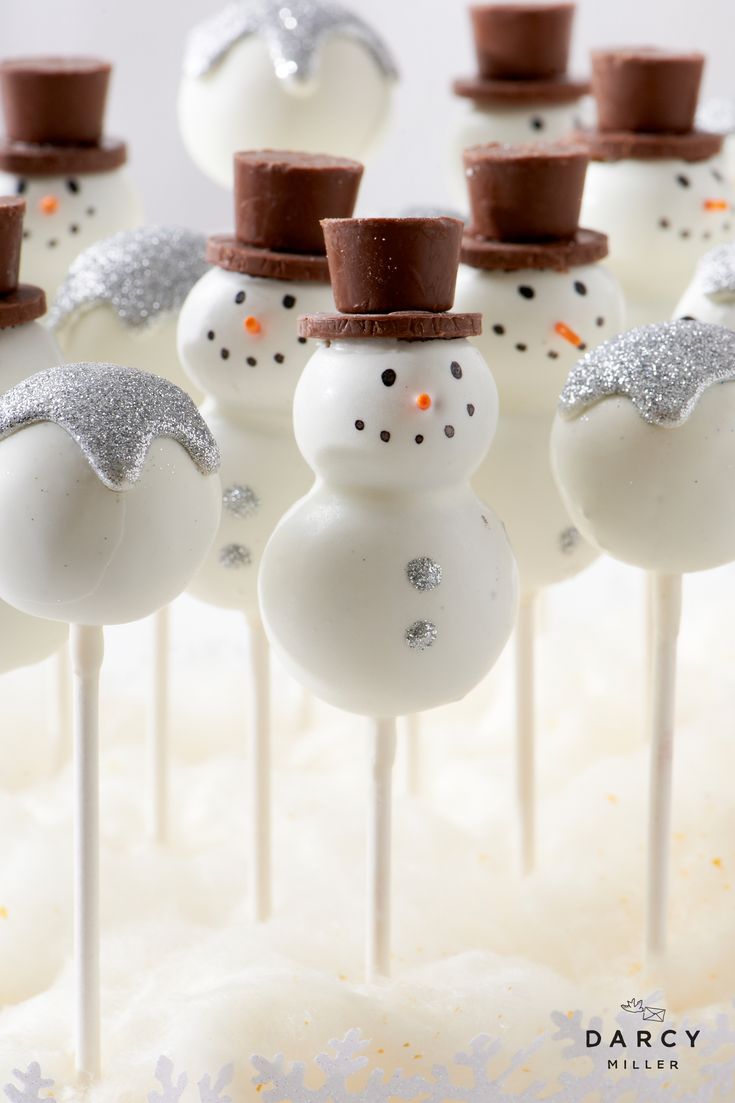 cake pops with frosting and snowmen on them