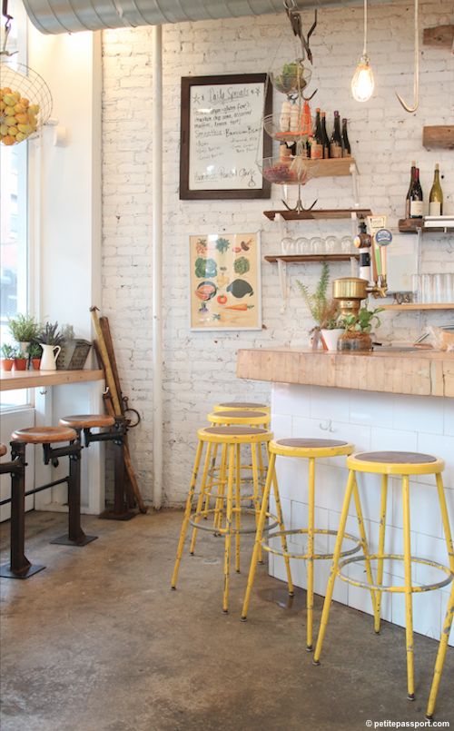 the interior of a restaurant with yellow stools