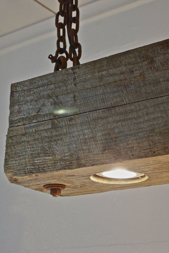 a wooden light fixture hanging from a ceiling