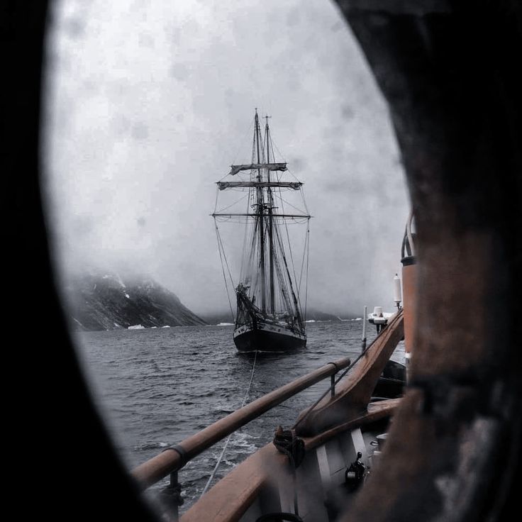 a ship sailing in the ocean on a cloudy day