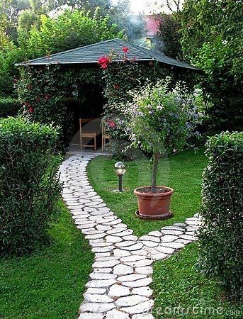 a stone path in the middle of a garden