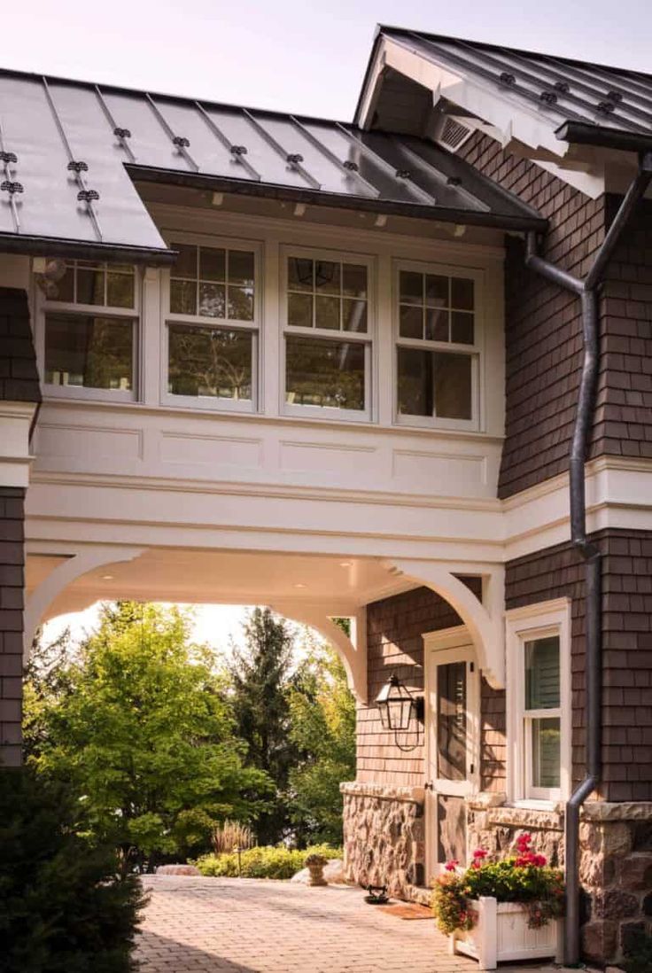 the front entrance to a house with an attached walkway