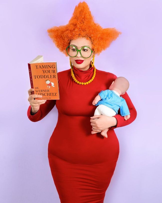 a woman in a red dress is holding a baby and reading a book that says taming your todder