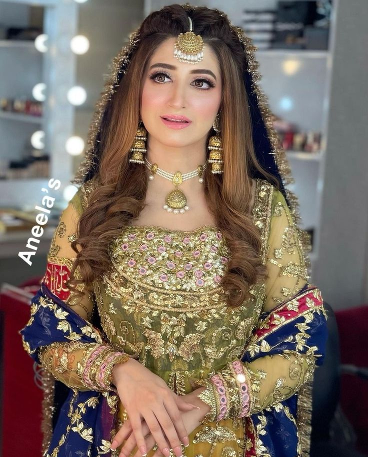 a woman in a bridal outfit posing for the camera