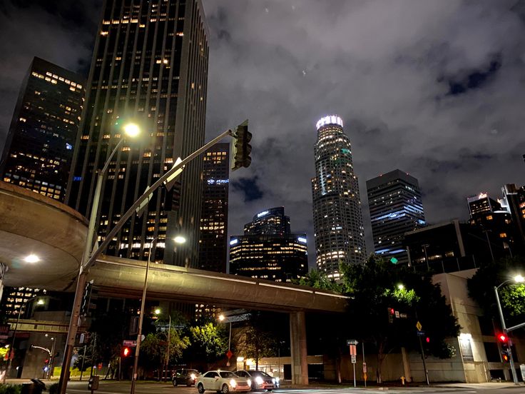 the city skyline is lit up at night