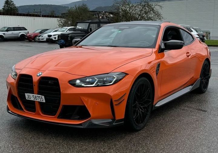 an orange sports car parked in a parking lot