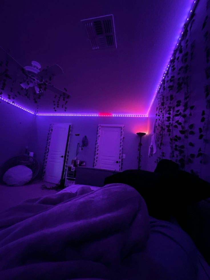 a bedroom with purple lighting in the ceiling