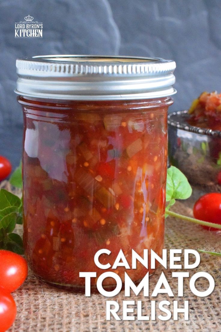 canned tomato relish in a jar with tomatoes around it