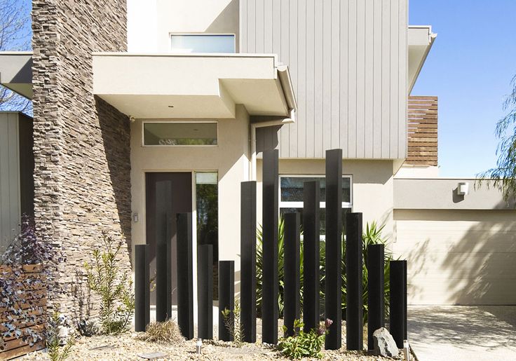 a house with a black fence in front of it