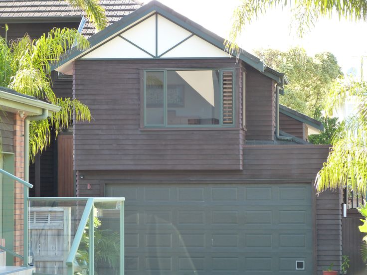 the house is brown and has two garages