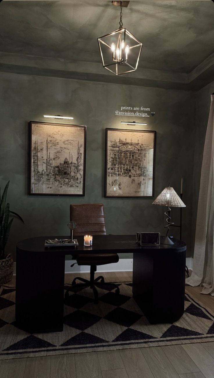 an office with two framed pictures on the wall and a desk in front of it