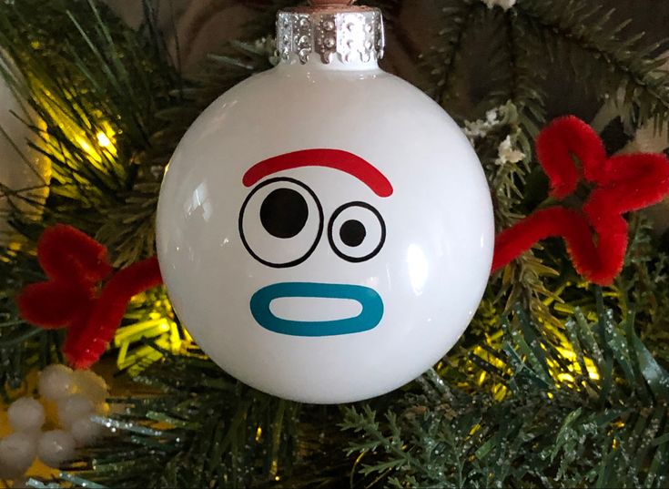 a white ornament hanging from a christmas tree