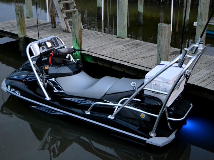 a black and white jet ski parked next to a dock