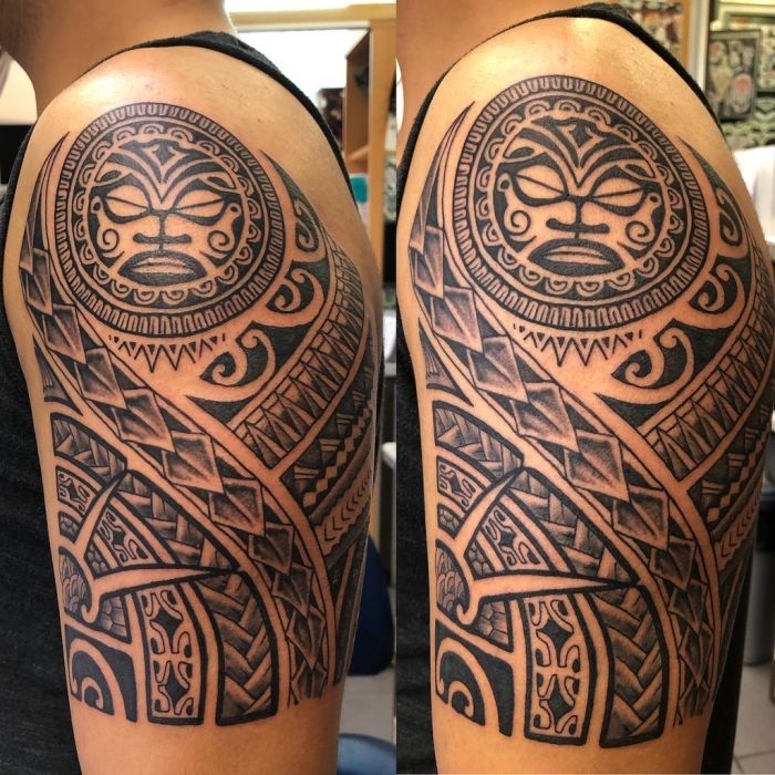 a man with a tattoo on his arm that has an image of a tiki