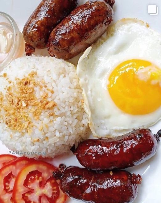 the plate has rice, sausages and eggs on it