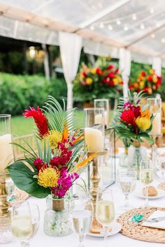 the table is set with flowers and candles