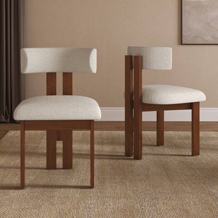 two white chairs sitting next to each other on top of a carpeted floor in front of a window