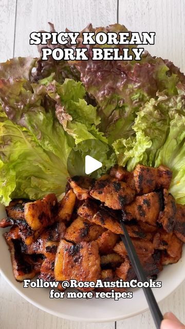 a white plate topped with lettuce and chicken