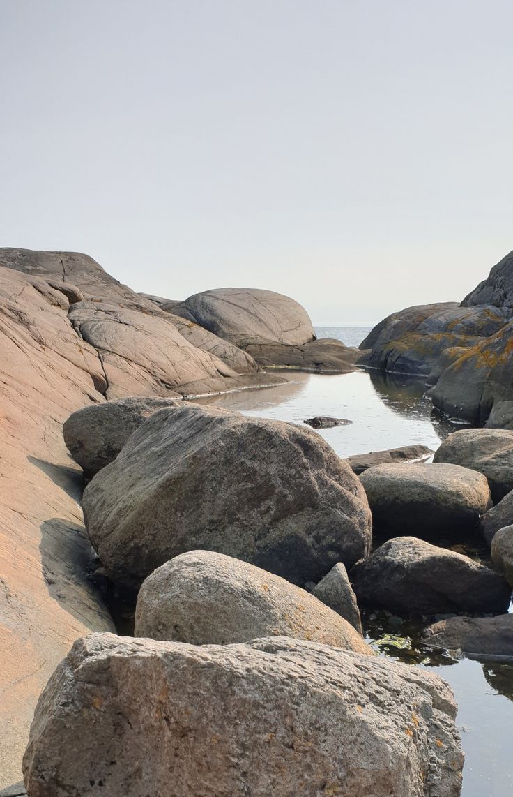 rocks on the beach with water in between them