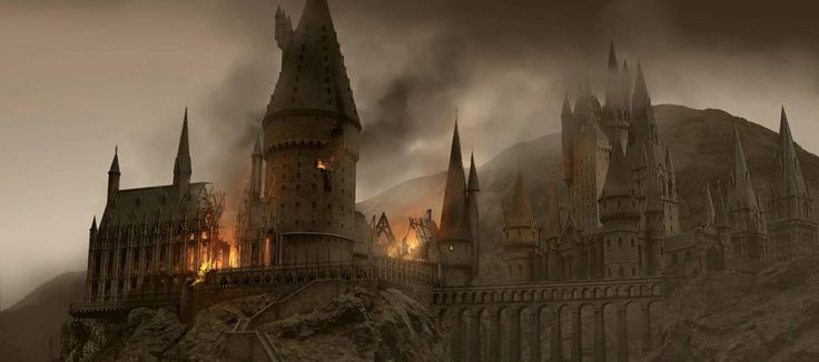 the hogwarts castle is lit up on a foggy day with dark clouds