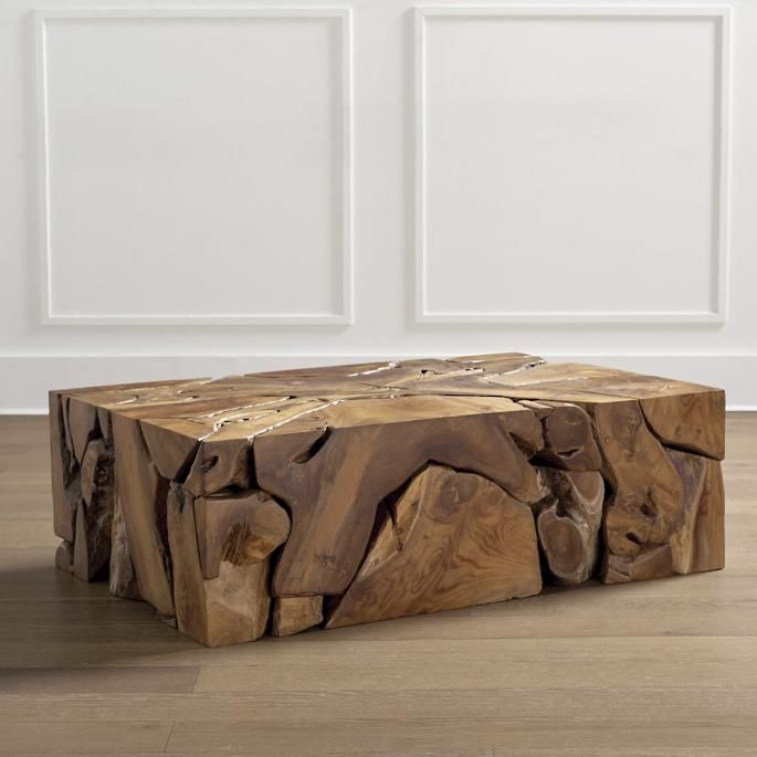 a wooden bench made out of logs on the floor