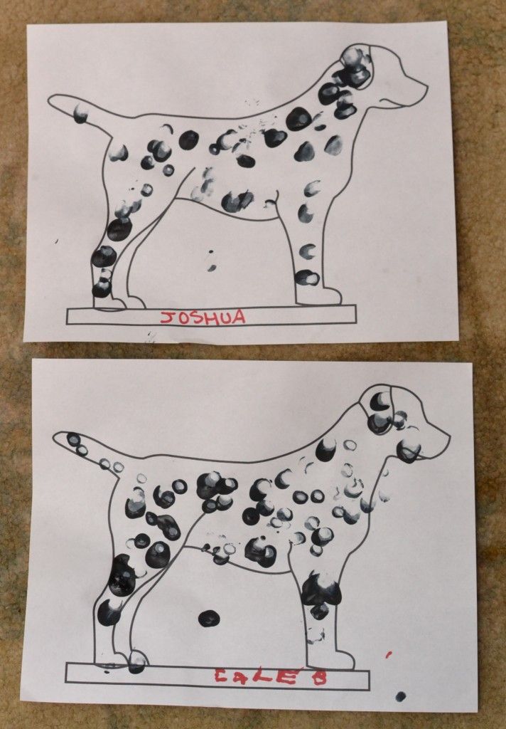 two paper cut outs with dogs on them, one is blue and the other has black dots