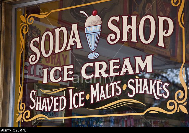 the sign for soda shop ice cream is on display in the store's window