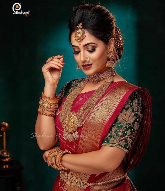 a woman in a red and gold sari