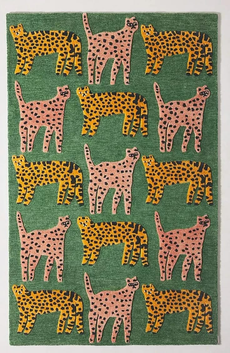 a green rug with pink and yellow cheetah on the front, and black dots on the back