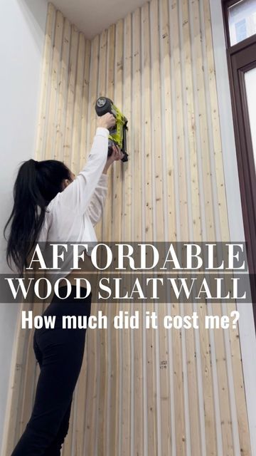 a woman is painting the wall with wood slat walls and text that reads, how much did it cost me?