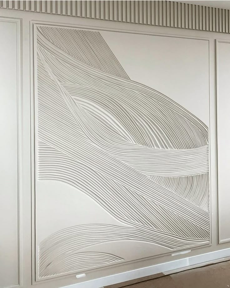 a white wall with an abstract design on it