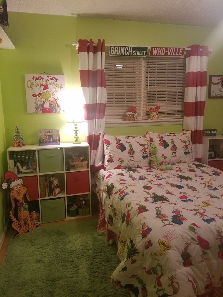 a bedroom decorated in green and red with the dr seuss theme on the walls