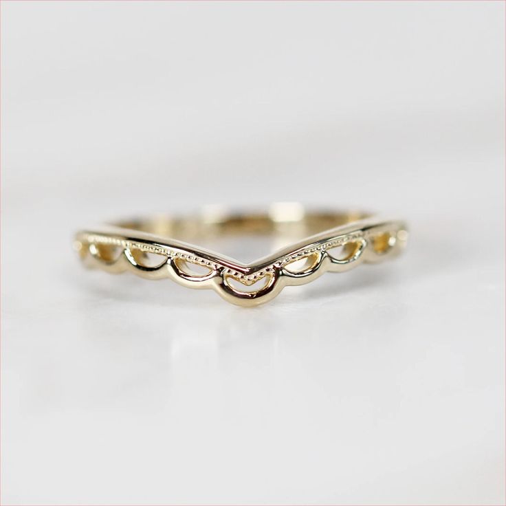 a gold wedding band that has been made to look like waves