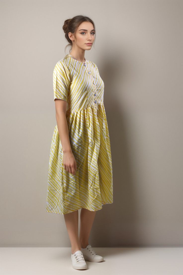 Elevate your summer wardrobe with the Tiska New York Yellow Patterned Cotton Casual Short Sleeve Summer Midi Dress. This knee-length dress features a chic and modest fit-and-flare style, perfect for a casual day out or dressing up for an elegant occasion. Patterned design in a beautiful yellow colored dress Half sleeves style that is perfect for warmer seasons Crafted from 100% cotton material, making it comfortable and breathable Hand wash only for easy care instructions Made in India with high-quality craftsmanship This dress is versatile enough to wear during spring and summer months. Its casual yet boho-chic style makes it suitable to wear on any occasion. It's sweet, minimalist design makes it the perfect choice if you're looking to show off your elegant sense of style while remaining Cotton Midi Dress For Summer, Cotton A-line Dress For Day Out, Cotton Fit And Flare Dress For Daywear, Cotton Fit And Flare Midi Dress, Cotton A-line Fit And Flare Midi Dress, Fitted Mid-length Sundress For Summer, Cotton Midi Dress With Short Sleeves For Day Out, Cotton Short Sleeve Sundress For Spring, Spring Cotton Sundress With Short Sleeves