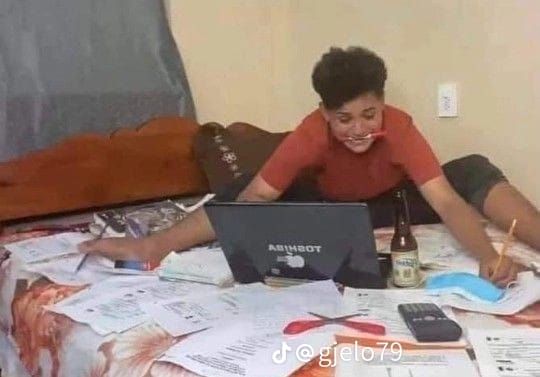 a woman sitting on top of a bed next to a laptop computer