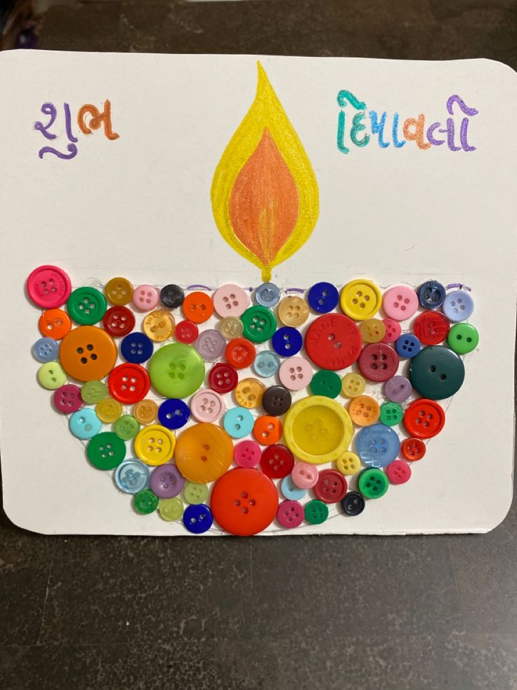 a birthday card with buttons and a lit candle