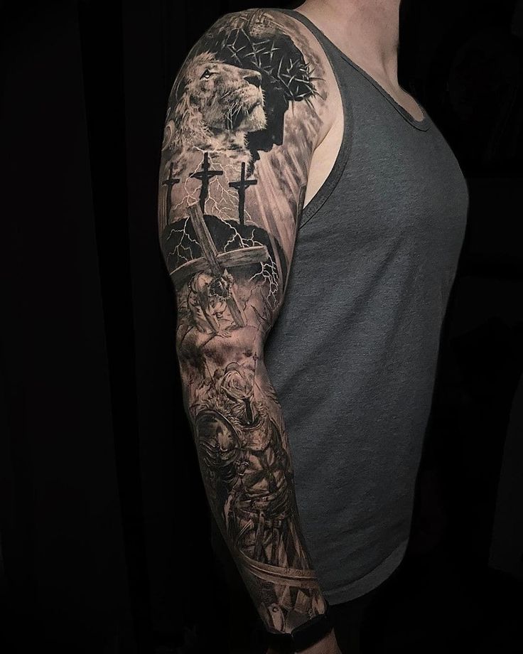 a man's arm with tattoos on it, and an image of the cross