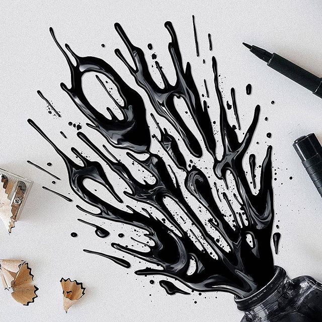 an artistically designed piece of paper with black ink on it, next to pens and scissors