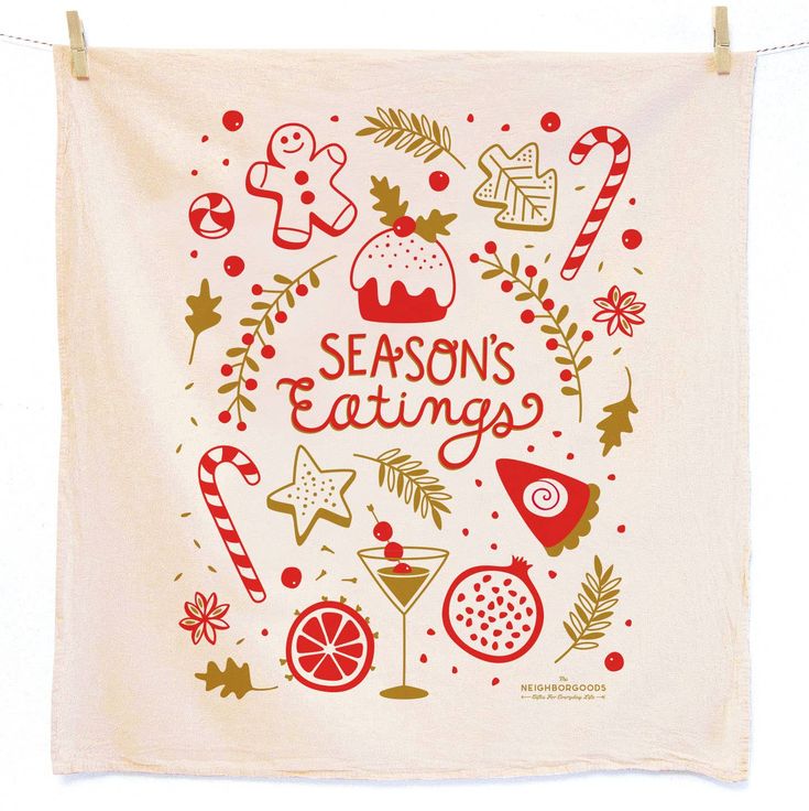 a tea towel hanging on a clothes line with the words season's eatings