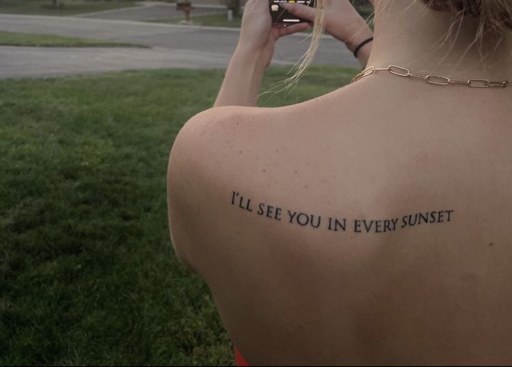 the back of a woman's neck with a tattoo saying, i'll'll see you in every sunset