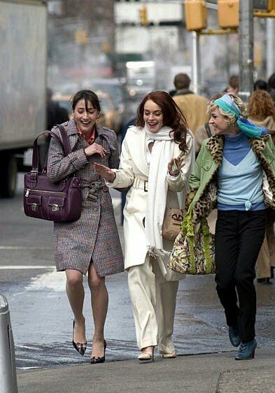 three women are walking down the street together