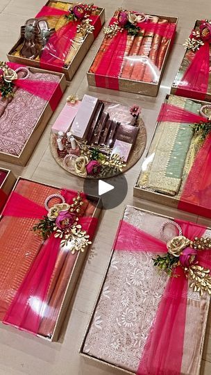 the table is covered with pink and gold wrapped gifts