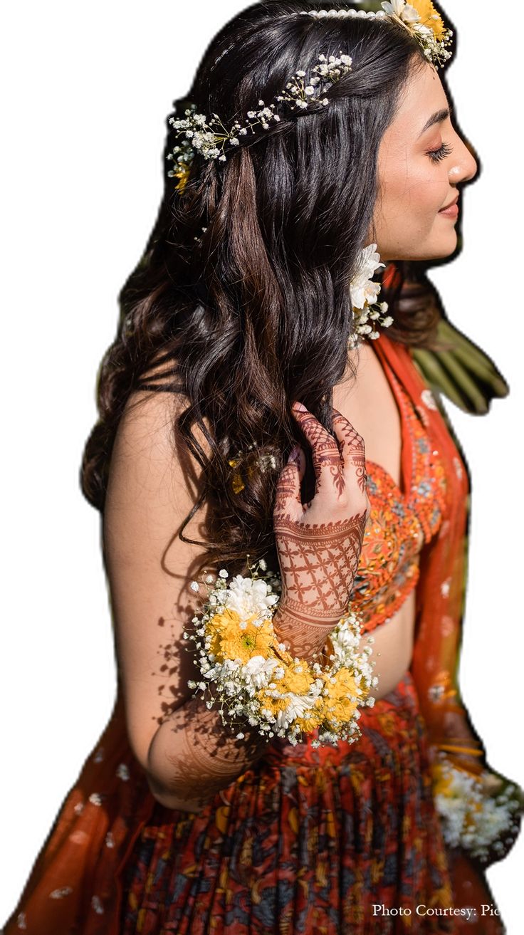 a woman with flowers in her hair is wearing a dress and holding a flower crown