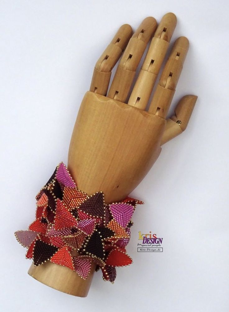 a wooden hand that has some beads on it